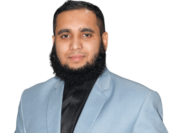 Ahsan Mahmood, photographed in a light grey suit against a plain background.